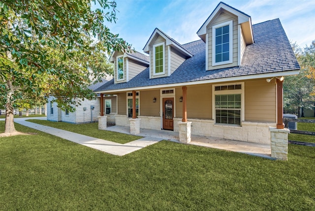 cape cod-style house featuring a porch and a front yard