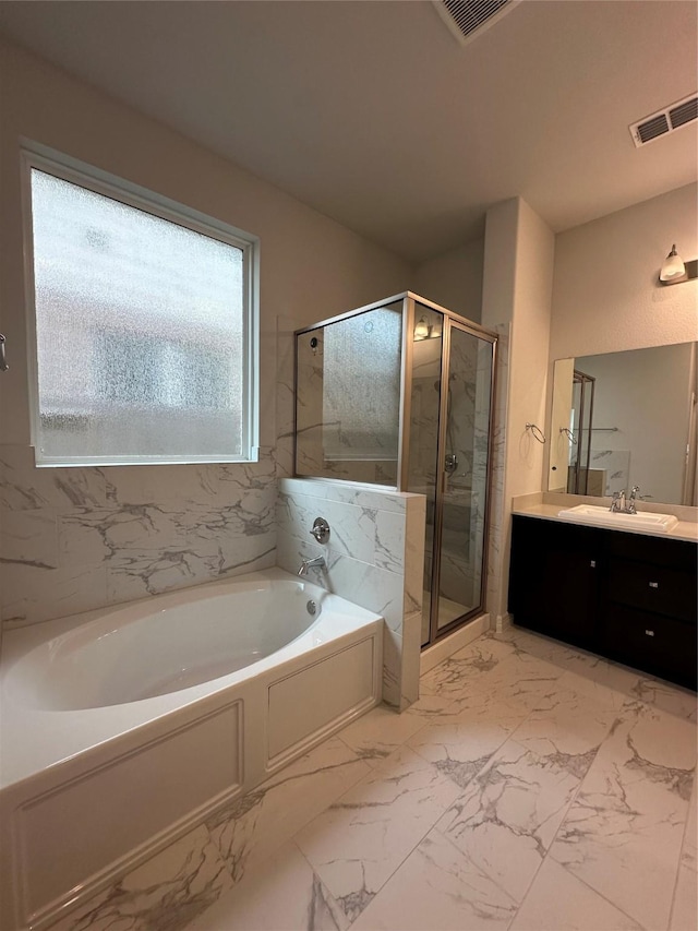 bathroom featuring vanity and separate shower and tub