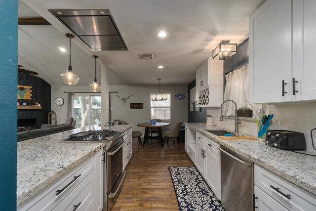 kitchen featuring white cabinetry, appliances with stainless steel finishes, sink, and hanging light fixtures