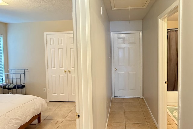 tiled bedroom with a textured ceiling