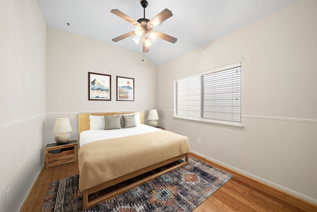 bedroom with vaulted ceiling, hardwood / wood-style floors, and ceiling fan