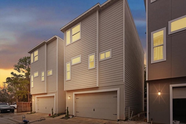 property exterior at dusk featuring a garage