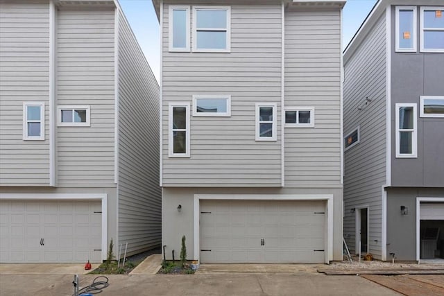 rear view of property with a garage