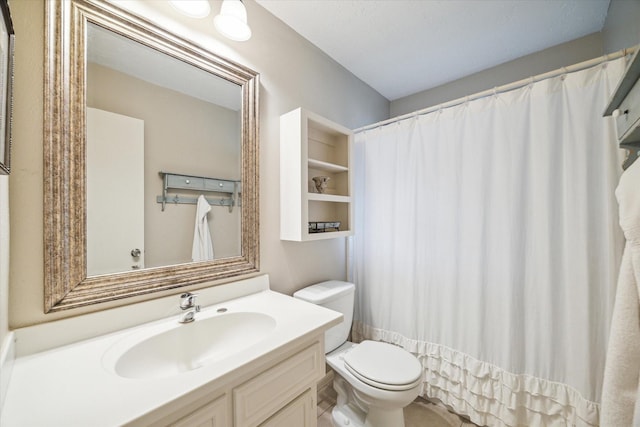 bathroom featuring vanity, curtained shower, and toilet