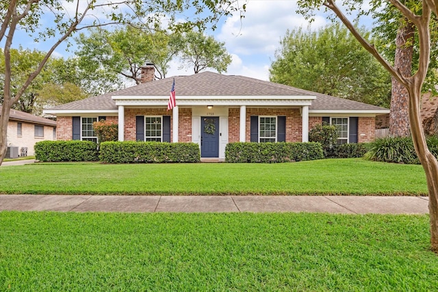 ranch-style house featuring central AC unit and a front lawn