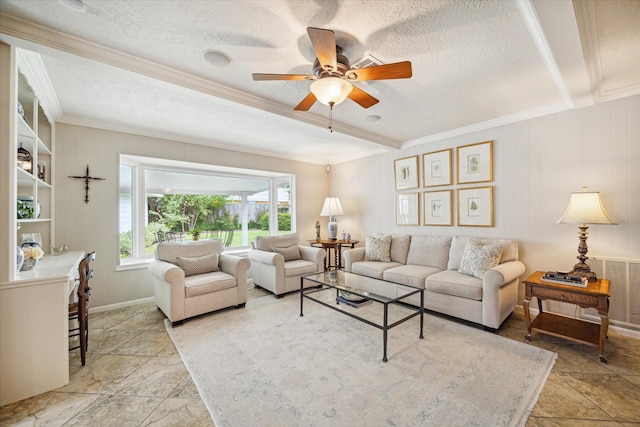 living room with ornamental molding, ceiling fan, and a textured ceiling