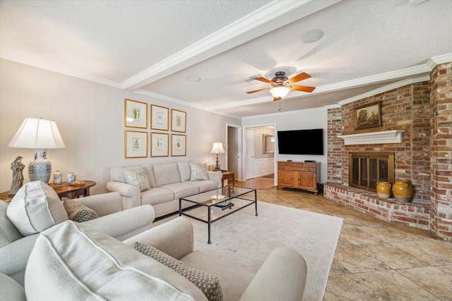 living room featuring ceiling fan, ornamental molding, a fireplace, and a textured ceiling