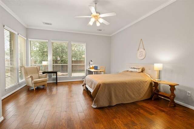 bedroom with multiple windows, ornamental molding, and dark hardwood / wood-style floors