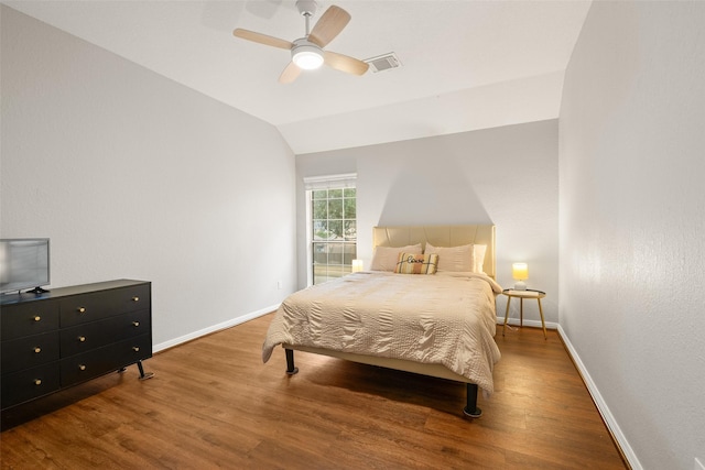 bedroom with hardwood / wood-style flooring, ceiling fan, and vaulted ceiling