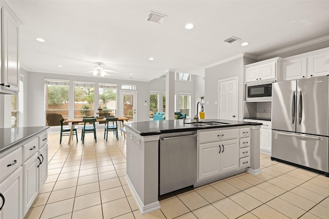 kitchen featuring white cabinetry, a kitchen island with sink, and stainless steel appliances