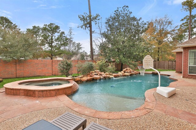 view of pool with an in ground hot tub