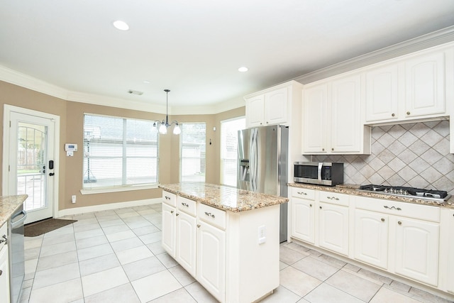 kitchen featuring light stone counters, appliances with stainless steel finishes, and white cabinets