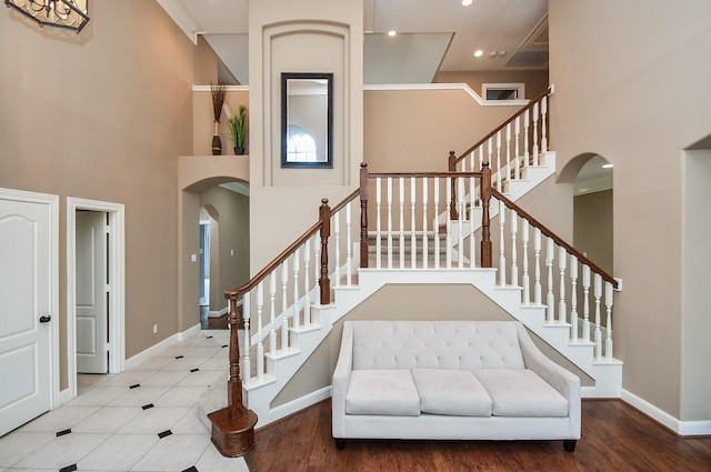 foyer featuring hardwood / wood-style floors and a high ceiling