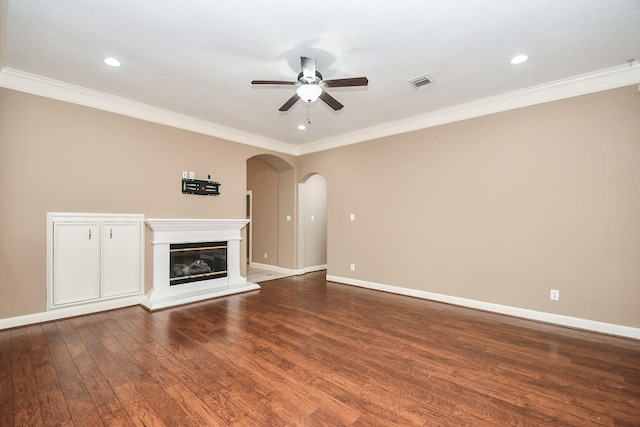 unfurnished living room featuring hardwood / wood-style flooring, ceiling fan, and crown molding