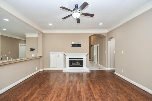 unfurnished living room featuring ornamental molding, dark hardwood / wood-style floors, and ceiling fan