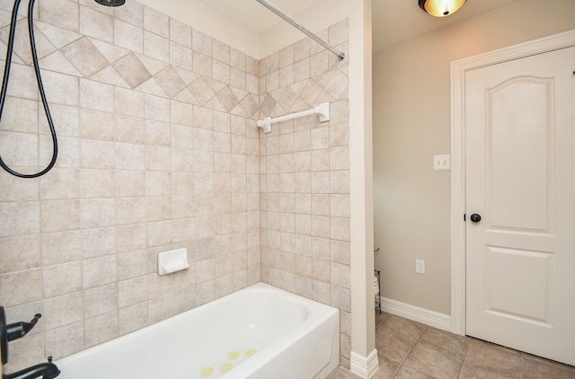 bathroom featuring tiled shower / bath and tile patterned floors