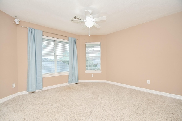 carpeted spare room featuring ceiling fan