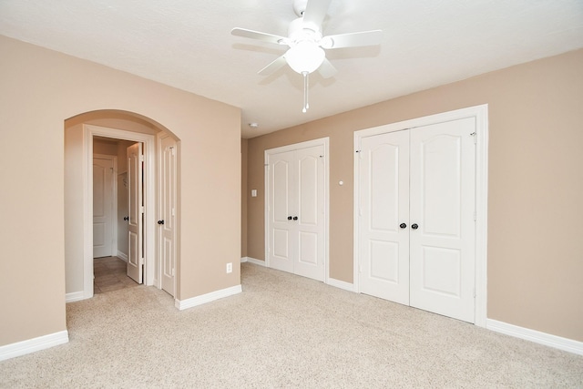 unfurnished bedroom featuring light colored carpet and ceiling fan