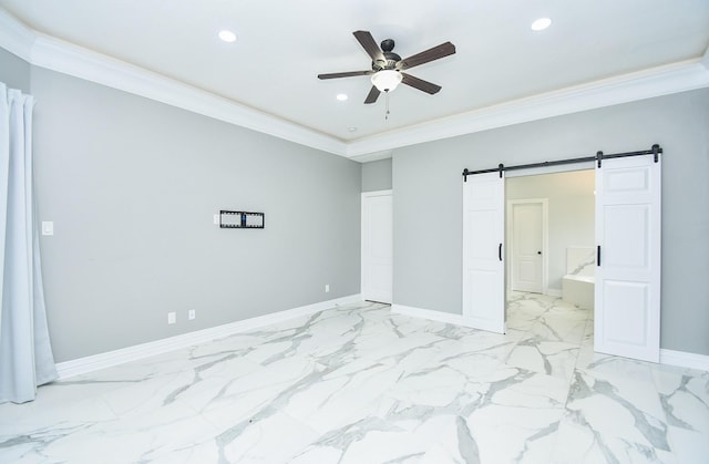 bedroom featuring crown molding, ensuite bath, a barn door, and ceiling fan