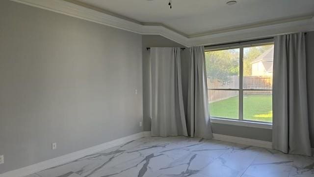 empty room with ornamental molding and a wealth of natural light