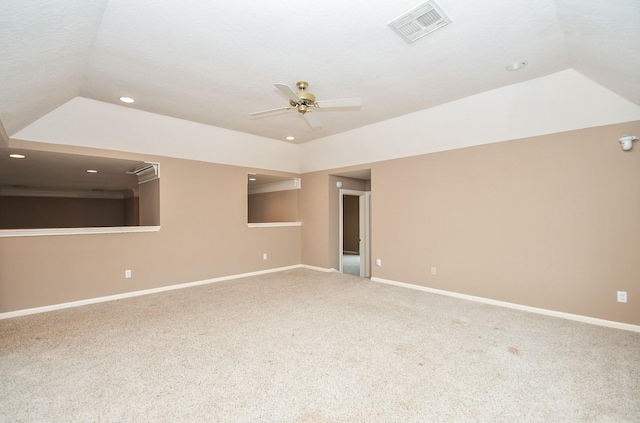 carpeted empty room with vaulted ceiling and ceiling fan