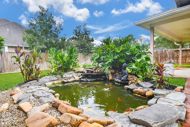 view of yard with a small pond