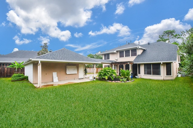 rear view of house with a yard and a patio