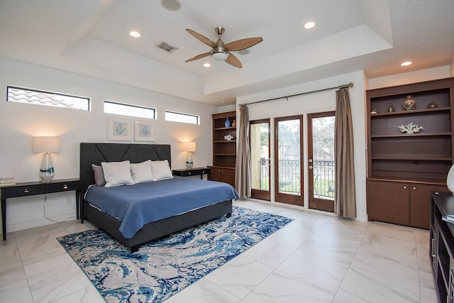 bedroom featuring a tray ceiling, ceiling fan, and access to outside