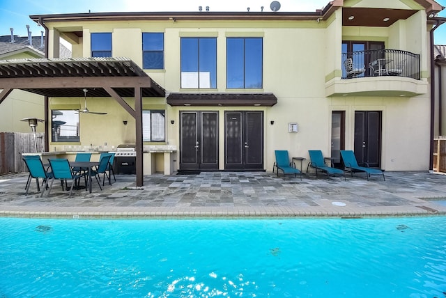 back of property featuring a patio and a balcony