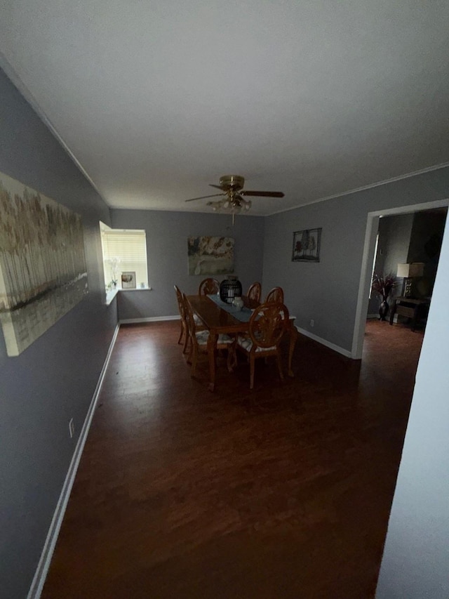 dining space featuring ceiling fan, vaulted ceiling, and dark hardwood / wood-style flooring