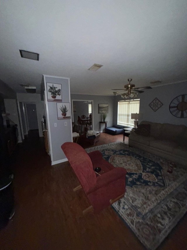 living room with ceiling fan and dark hardwood / wood-style flooring