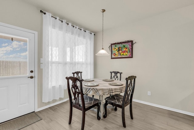 dining room featuring hardwood / wood-style flooring and a healthy amount of sunlight