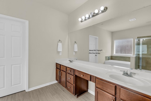 bathroom featuring independent shower and bath, vanity, and hardwood / wood-style floors