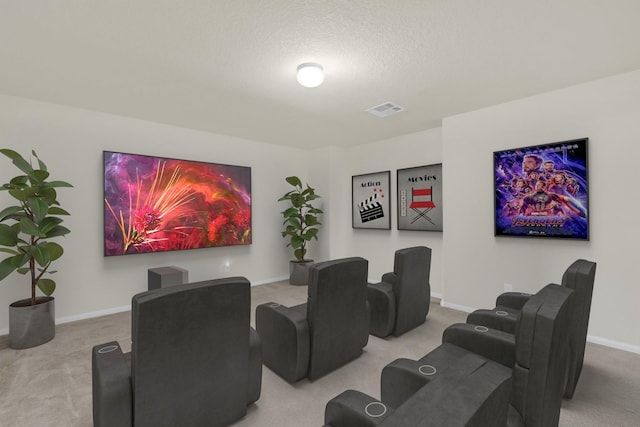 carpeted cinema room with a textured ceiling