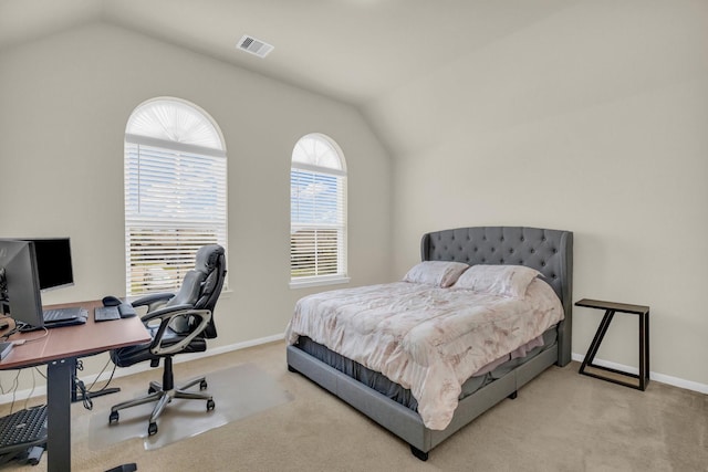 bedroom featuring vaulted ceiling and light colored carpet