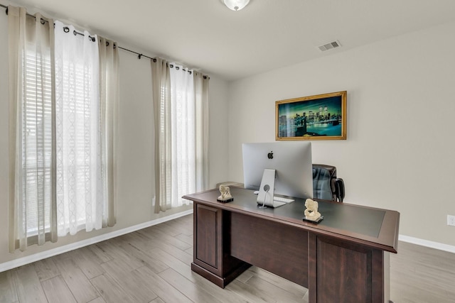 office space with light hardwood / wood-style flooring