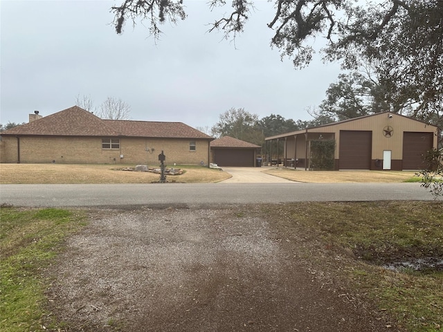 exterior space with an outdoor structure and a detached garage