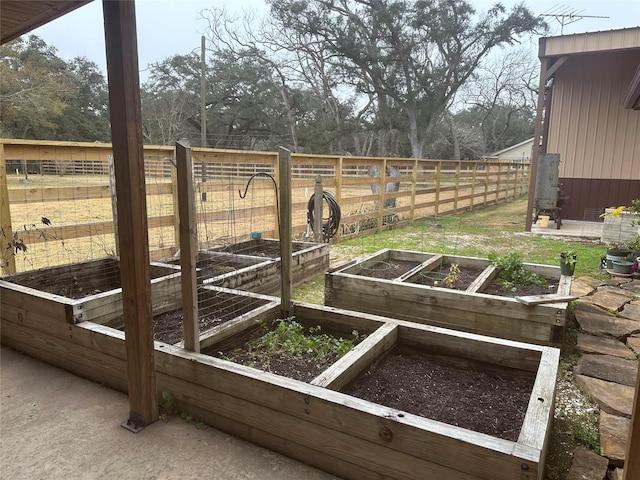 view of yard featuring a vegetable garden and fence