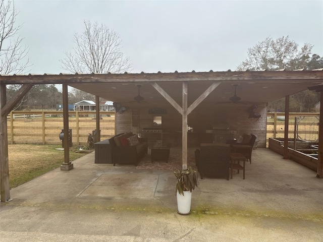 view of patio / terrace featuring ceiling fan, a carport, an outdoor hangout area, and fence