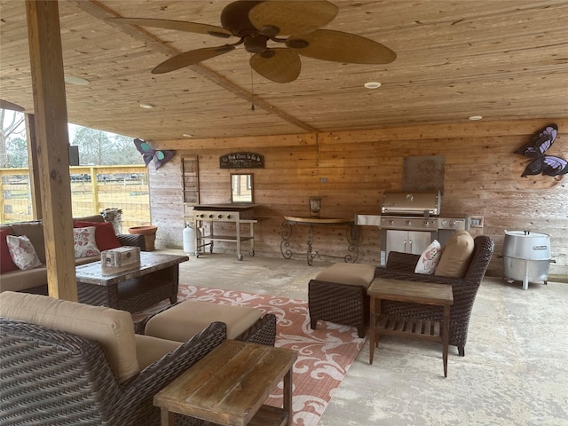 view of patio with area for grilling, an outdoor living space, and a ceiling fan