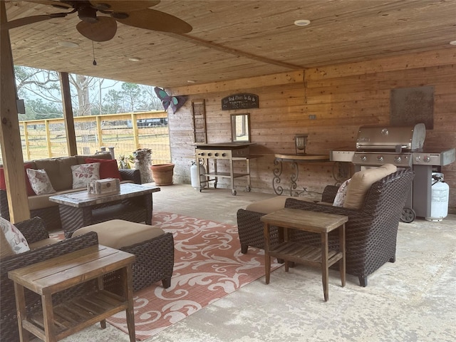 view of patio featuring fence, an outdoor living space, and a ceiling fan