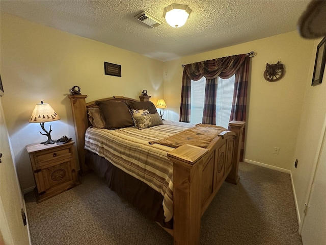 bedroom featuring baseboards, carpet, visible vents, and a textured ceiling