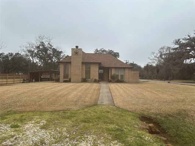 view of front of home with a carport and a front lawn