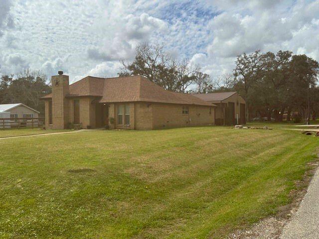 exterior space with a chimney and a front yard