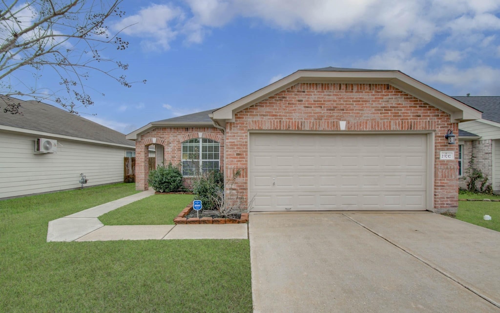 single story home with a garage, a front yard, and an AC wall unit