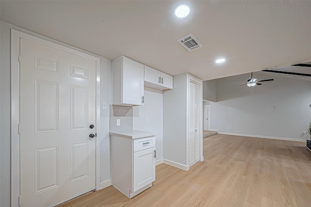 kitchen featuring ceiling fan, light hardwood / wood-style flooring, and white cabinets