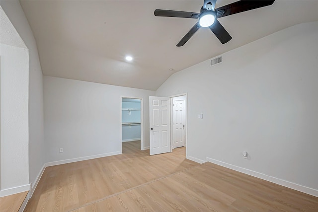 spare room featuring vaulted ceiling, ceiling fan, and light hardwood / wood-style floors