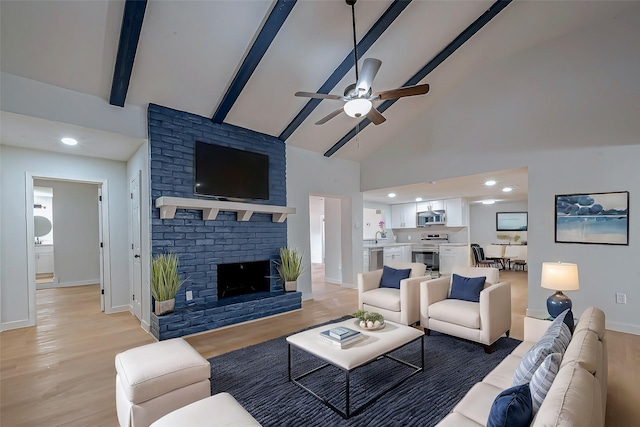 living room featuring light hardwood / wood-style flooring, beam ceiling, a fireplace, and high vaulted ceiling