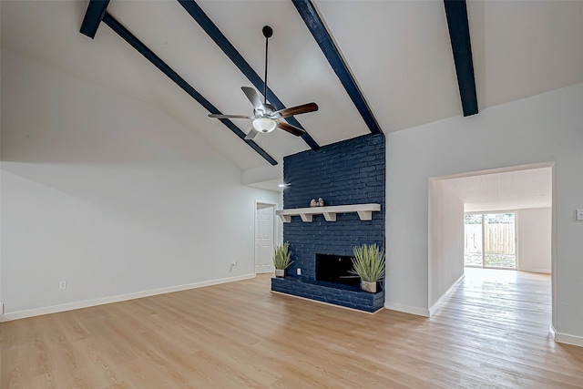 unfurnished living room featuring beamed ceiling, a brick fireplace, high vaulted ceiling, and light hardwood / wood-style flooring