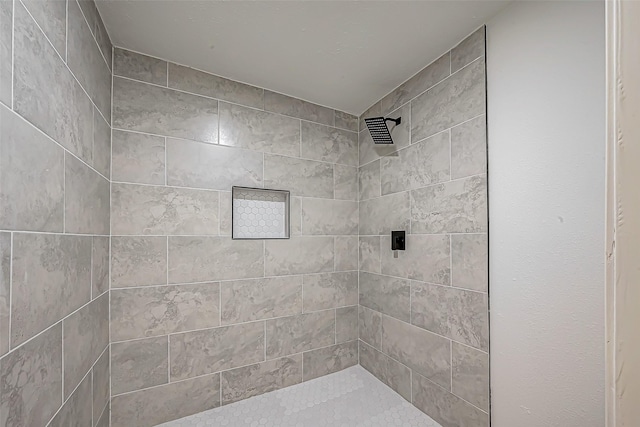 bathroom with a tile shower